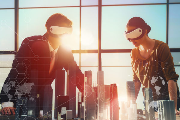 two business persons are developing a project using virtual reality goggles. the concept of technologies of the future