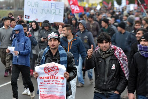 Migrants march in the French port city of Calais