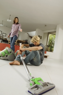 Mother and son in living room, vacuum cleaner, indoors