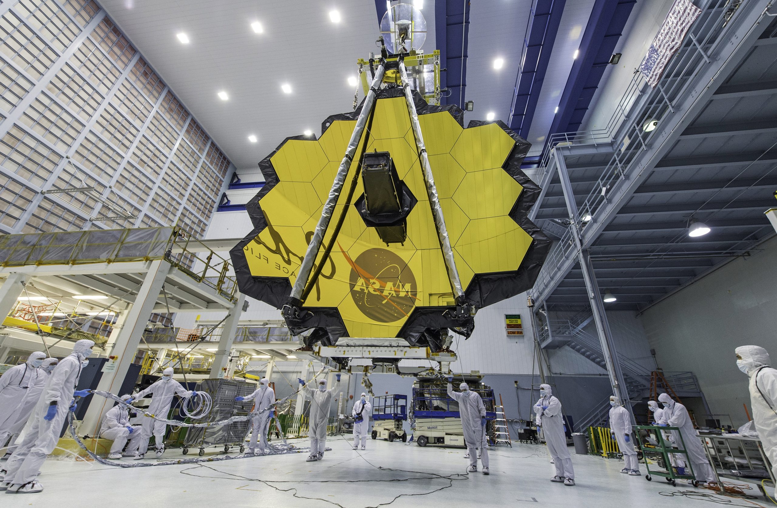 FILE - In this April 13, 2017 file photo provided by NASA, technicians lift the mirror of the James Webb Space Telescope using a crane at the Goddard Space Flight Center in Greenbelt, Md. The telescope's 18-segmented gold mirror is specially designed to capture infrared light from the first galaxies that formed in the early universe. (Laura Betz/NASA via AP, File) | DeviceDaily.com