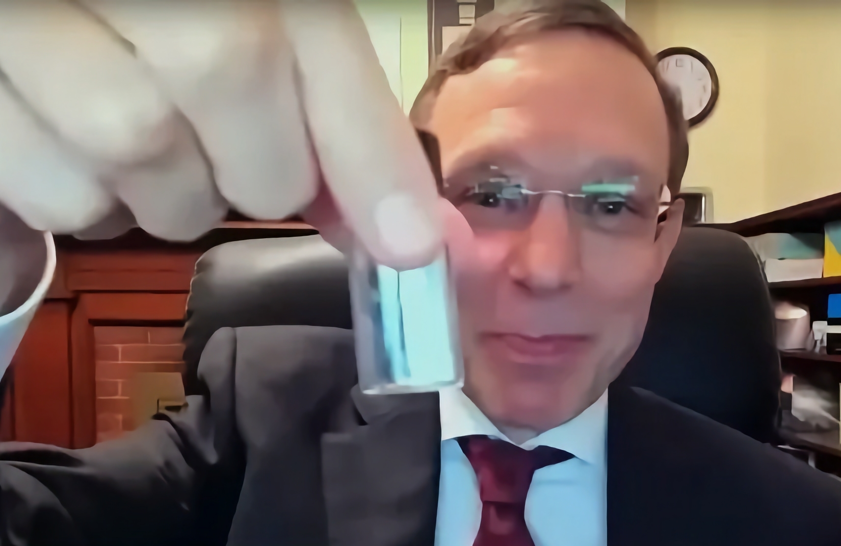 Harvard astrophysicist Avi Loeb holding a vial while looking at the camera with a proud smile. | DeviceDaily.com