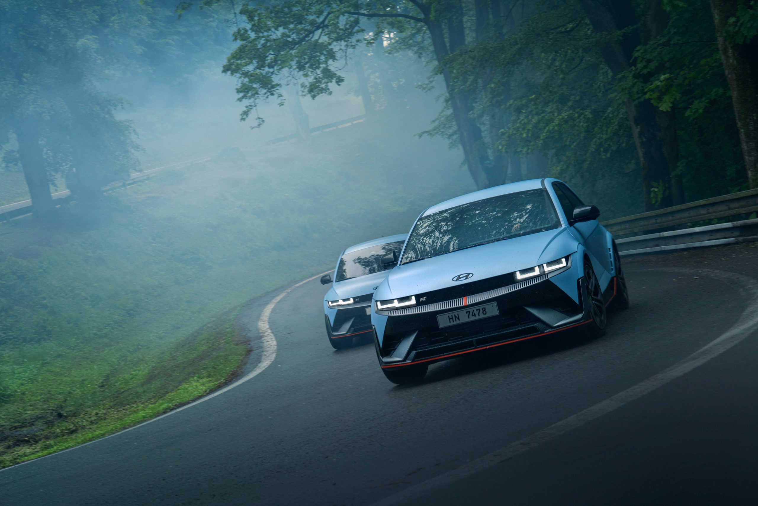 Two Hyundai Ioniq 5 Ns on a road in gloomy weather. | DeviceDaily.com