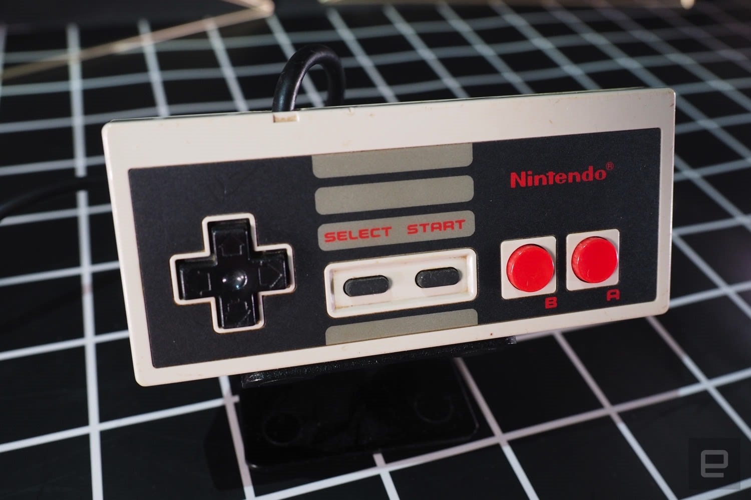 A close up of a Nintendo Entertainment System controller. | DeviceDaily.com