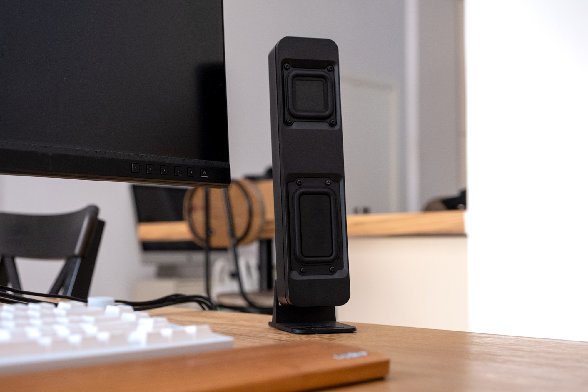 A Drop BMR1 speaker pictured on a desk next to a PC monitor and keyboard. | DeviceDaily.com