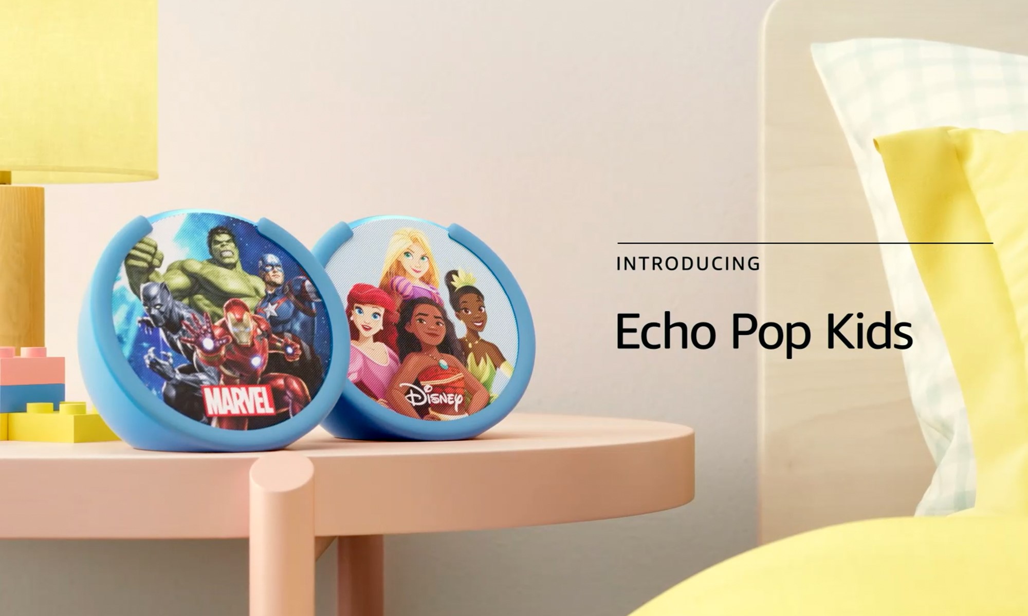 Product photo for Amazon Echo Pop Kids. A Marvel-themed speaker sits next to a Disney Princess speaker on a child's bedside table. | DeviceDaily.com